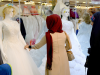 Iraqi women look at wedding gowns outside a bridal shop