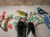 Girls look at pictures of birds at their house in Gaitania, Tolima department, Colombia, on October 25, 2021.