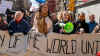 Demonstrators hold signs during a march honoring International Women's Day March 8, 2025 in New York City.