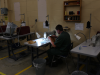 A prisoner works sewing uniforms while serving her sentence at a 