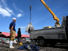 Workers load flash-frozen fish onto a vehicle at the Benoa fishing port in Denpasar, Indonesia's Bali island, on February 2, 2024.