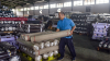 A worker stacks rolls of fabric ready for export at the Trisula Textile Industries factory in Cimahi, West Java on April 15, 2025. The 32 percent tariffs imposed on Indonesia made it one of Asia's hardest hit by US President Donald Trump's sweeping measures.