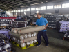 A worker stacks rolls of fabric ready for export at the Trisula Textile Industries factory in Cimahi, West Java on April 15, 2025. The 32 percent tariffs imposed on Indonesia made it one of Asia's hardest hit by US President Donald Trump's sweeping measures.