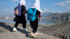 Afghan primary school girls make their way to home near the Shuhada lake in Kabul on March 24, 2024.
