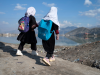 Afghan primary school girls make their way to home near the Shuhada lake in Kabul on March 24, 2024.